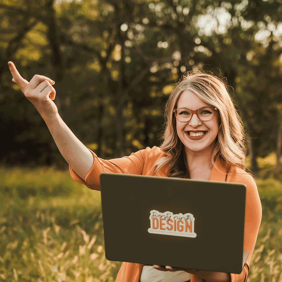 Gif of Hayley Royle, owner of 29th Design, standing in a green Nebraska field while pointing to her laptop that she is holding.