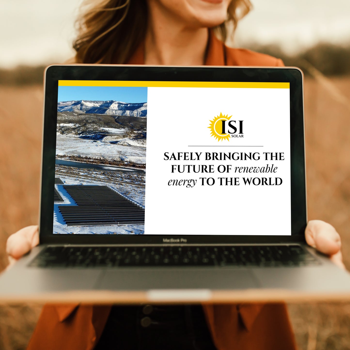 Photo of a woman holding a laptop with the ISI Solar website on the screen.