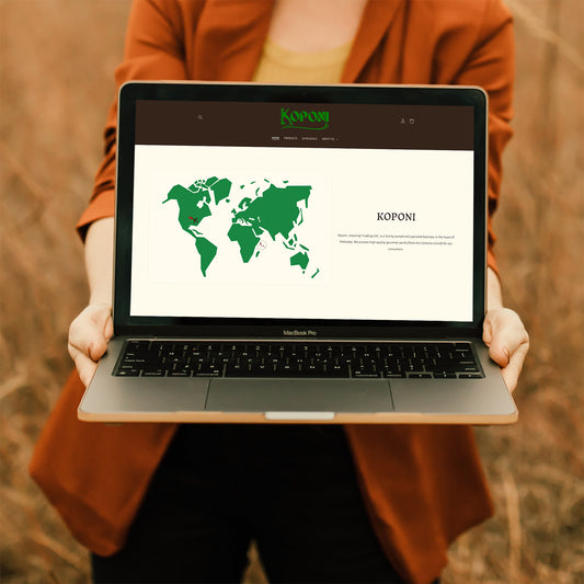 A woman holding open her computer screen with Koponi Vanilla's website on the screen